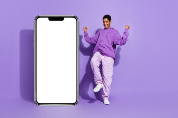 Photo of funny positive transgender person dance poster empty space wear hoodie isolated purple color background