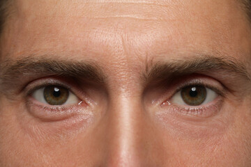 Man with beautiful hazel eyes as background, closeup