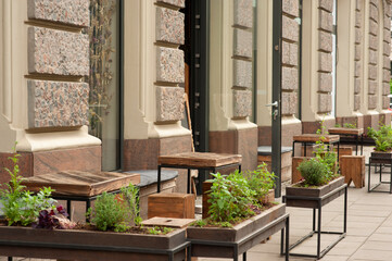 Wooden stools and tables near cafeteria outdoors