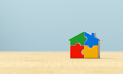 Multicolored puzzle house on a wooden surface. 3d render illustration.