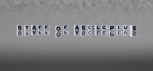 staff of asclepius word or concept represented by black and white letter cubes on a grey horizon...