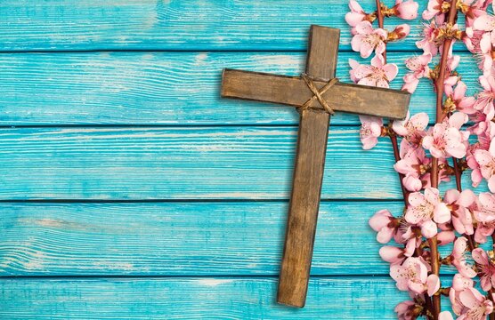Christian cross and border of flowers on a desk background