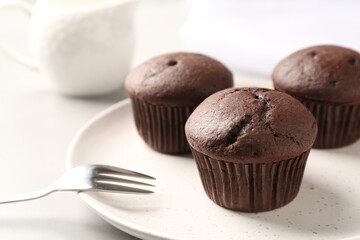 Delicious chocolate cupcakes on white table, closeup