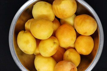 Large metal bowl with peaches
