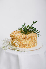 Cake Napoleon of puff pastry with sour cream on a white background. Copy space.