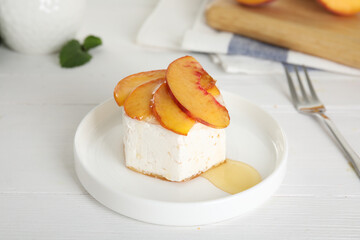 Delicious peach dessert on white wooden table
