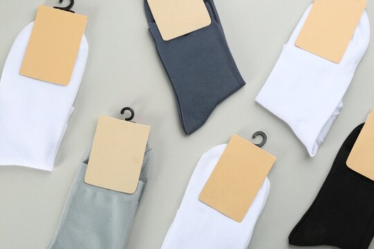 Soft cotton socks on grey background, flat lay