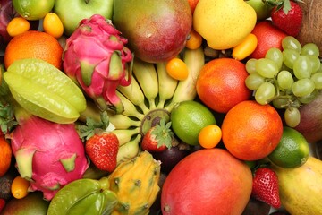 Assortment of fresh exotic fruits as background, top view