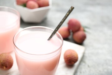 Delicious lychee cocktail and fresh fruits on table, closeup. Space for text