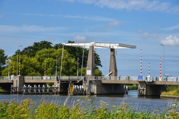 Breezand, Netherlands. August 2022. A iron lift bridge over a canal near Breezand.