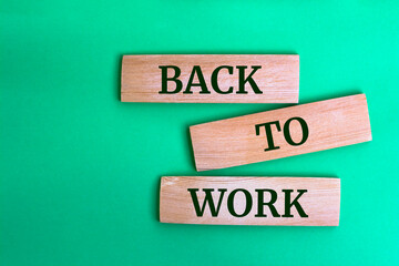 Wooden blocks with words 'back to work'.