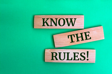 Wooden blocks with words 'Know The Rules!'.