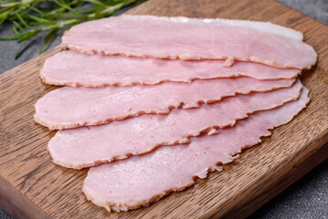 Sliced ham on wooden background. Fresh prosciutto. Pork ham sliced