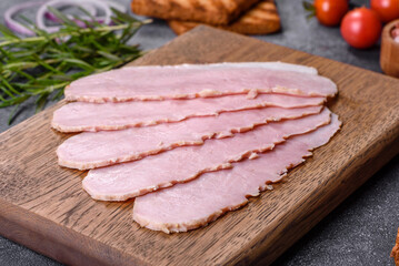Sliced ham on wooden background. Fresh prosciutto. Pork ham sliced
