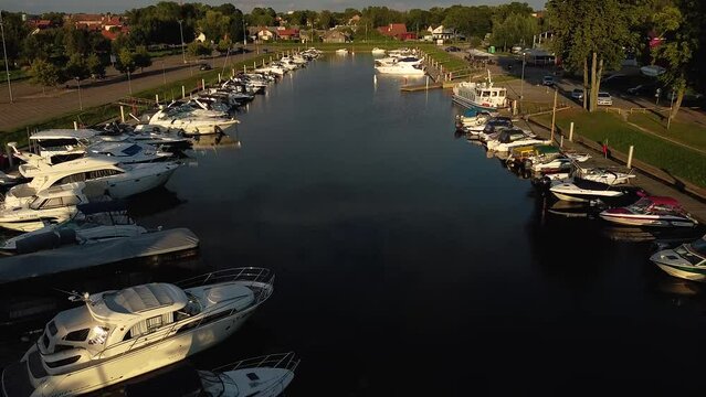 Up to Down shot. Arial drone shot of small town Marina with a lot of private ships harbored. Silute, Lithuania, Europe.