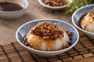 Taiwanese savory rice pudding Wa gui with chopped dried radish and soy sauce