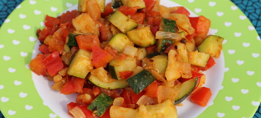 a vegetable pan with courgettes, onions, tomatoes, potatoes and peppers