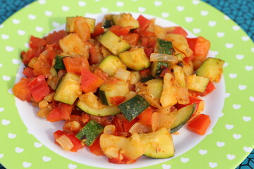 a vegetable pan with courgettes, onions, tomatoes, potatoes and peppers