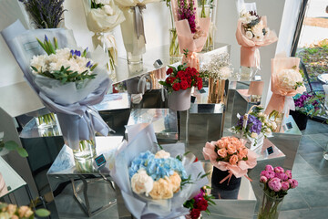 Many different colors on the stand in the flower shop