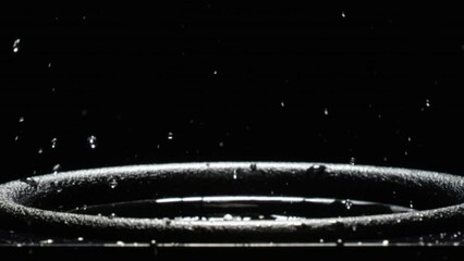 Water splashes on audio speaker. Vibrations of low bass over water in a music speaker. Black bass woofer. Subwoofer with water. The liquid jumps to the rhythm of the music at the party. Slow motion
