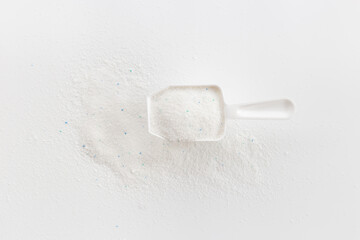 White washing powder with measuring cup. Laundry day concept