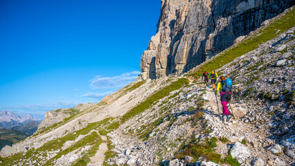 Naklejka premium Group of hikers ascending the mountain in Dolomites