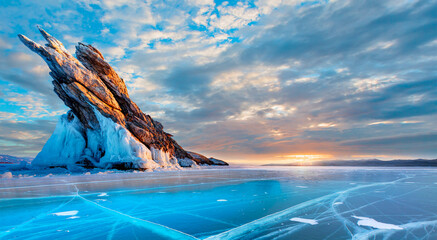 Ogoy island on winter Baikal lake with transparent cracked blue ice at sunrise - Baikal, Siberia,...