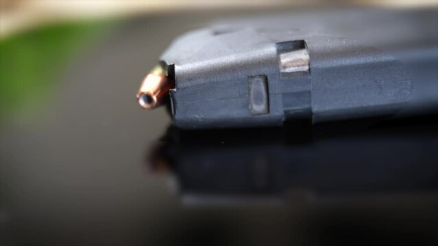 A gun magazine with 9mm hollow-point bullets - turning macro