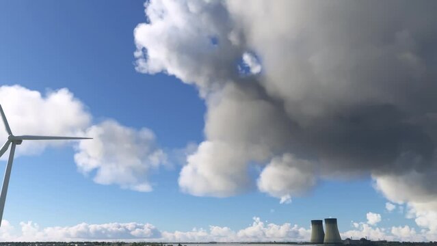 Side shot of a windmill and nuclear power plant in Doel. Belgium