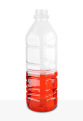 plastic bottle with half of red liquid
