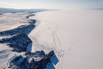 Winter landscape sunny day blue clear ice on Baikal lake aerial top view