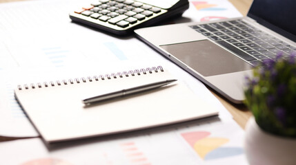 Businessman working on desk and using calculator to calculate business data, accounting documents and laptop in office. Business concept