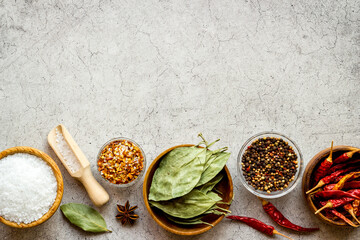 Colorful cooking background with spices and herbs in bowls, top view