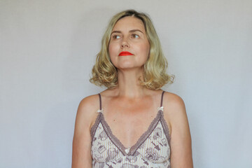 Naklejka premium Beautiful middle-aged blond woman on a white background