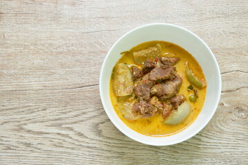 spicy boiled beef meat with eggplant in coconut milk green curry soup on bowl