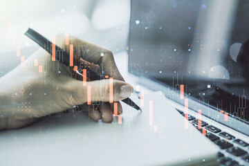 Creative concept of crisis chart illustration with hand writing in notebook on background with laptop. Global crisis and bankruptcy concept. Multiexposure