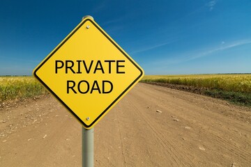 Yellow Private Road sign against sky background