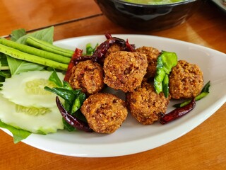 Spicy deep fried pork larb , Laab Moo Tod , Thai style recipe

