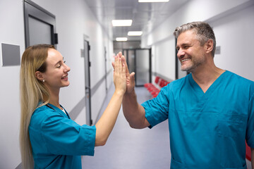 Doctors give high five to each other