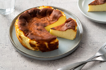Delicious sliced baked Basque Burnt Cheesecake in a plat served for eating.