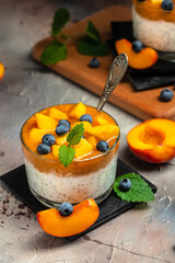 Healthy chia pudding with yogurt and fruit Peach and blueberry. Homemade dessert with fruits. place for text, top view