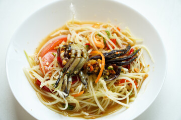 Spicy papaya salad (Som Tum) Thai traditional food isolated on white background, clipping path included