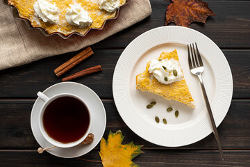 A piece of homemade pumpkin pie and a cup of tea