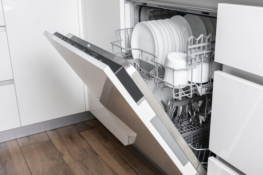 Open dishwasher with clean dishes