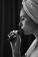 A girl is blowing smoke from a vape, a portrait of a girl with red lips who smokes.