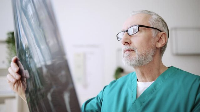 Closeup of doctor looking at x-ray picture in rehabilitation clinic, physiatrist