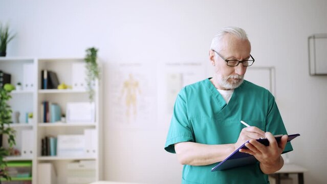 Mature doctor in his 60s working in rehabilitation center, certified physiatrist