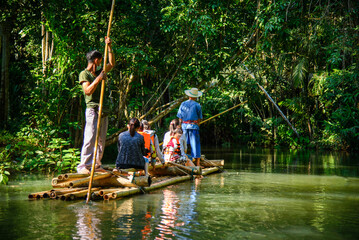Tourist sitting bamboo rafts floating in clear water in the morning at Pan River Ban Mae Pan, Long...