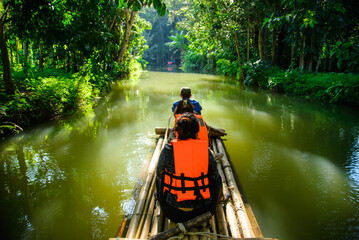 Tourist sitting bamboo rafts floating in clear water in the morning at Pan River Ban Mae Pan, Long...