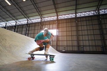 asian child or kid girl playing skateboard or surf skate and get off the ramp or down from wave ramp to bottom turn hand touching floor in skatepark by extreme sports to wearing helmet and body safety © kornnphoto